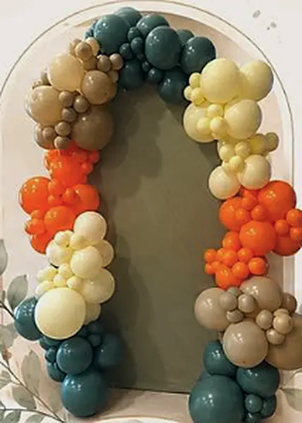 Emerald, sand, orange and butter garland on an olive arch