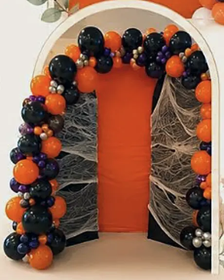 Black and orange Halloween arch with webs