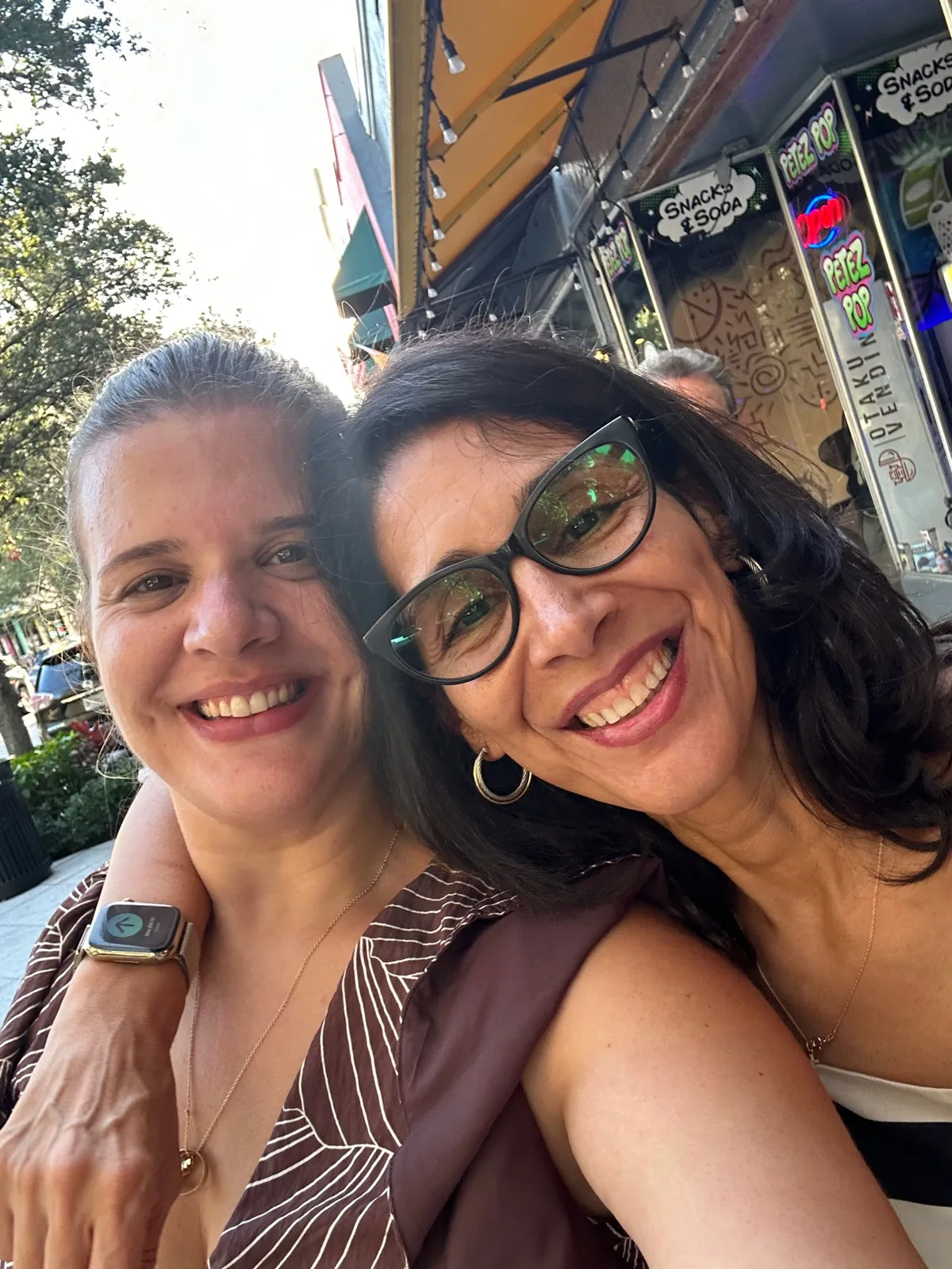 Bianca and her mom, the mother-daughter duo behind Pop It Up, smiling together downtown