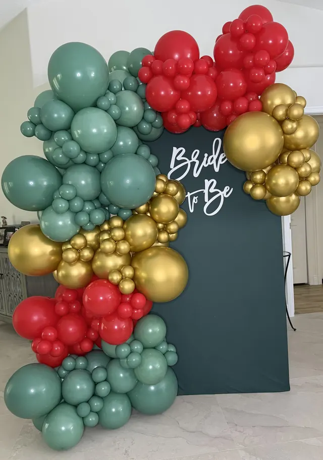 Red, sage and gold chrome garland around a Bride to Be backdrop