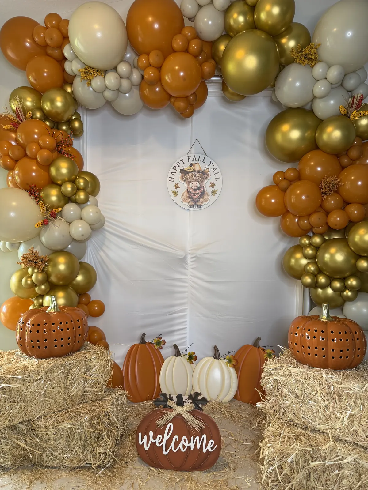 Orange, gold and cream fall garland with pumpkins and hay bales