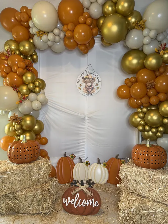 Orange, gold and cream fall garland with pumpkins and hay bales