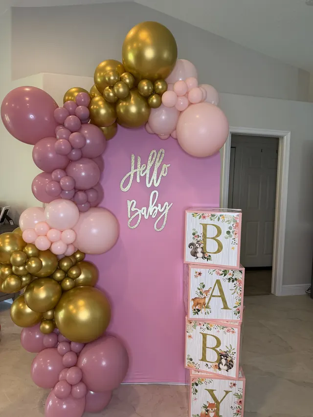 Dusty rose, pink and gold garland with a Hello Baby sign and BABY blocks